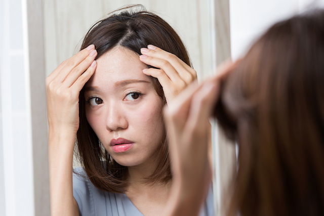 分け目を整える女性