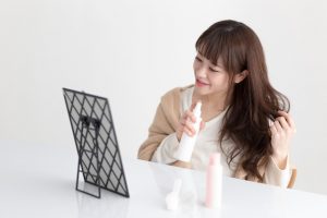 制汗スプレーを使う女性